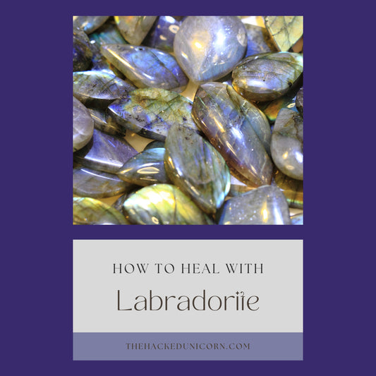 image of labradorite stones with beautiful flashes of blue, yellow and green with a guide to using labradorite at the bottom right. at the top is the name of the website, www.thehackedunicorn.com.